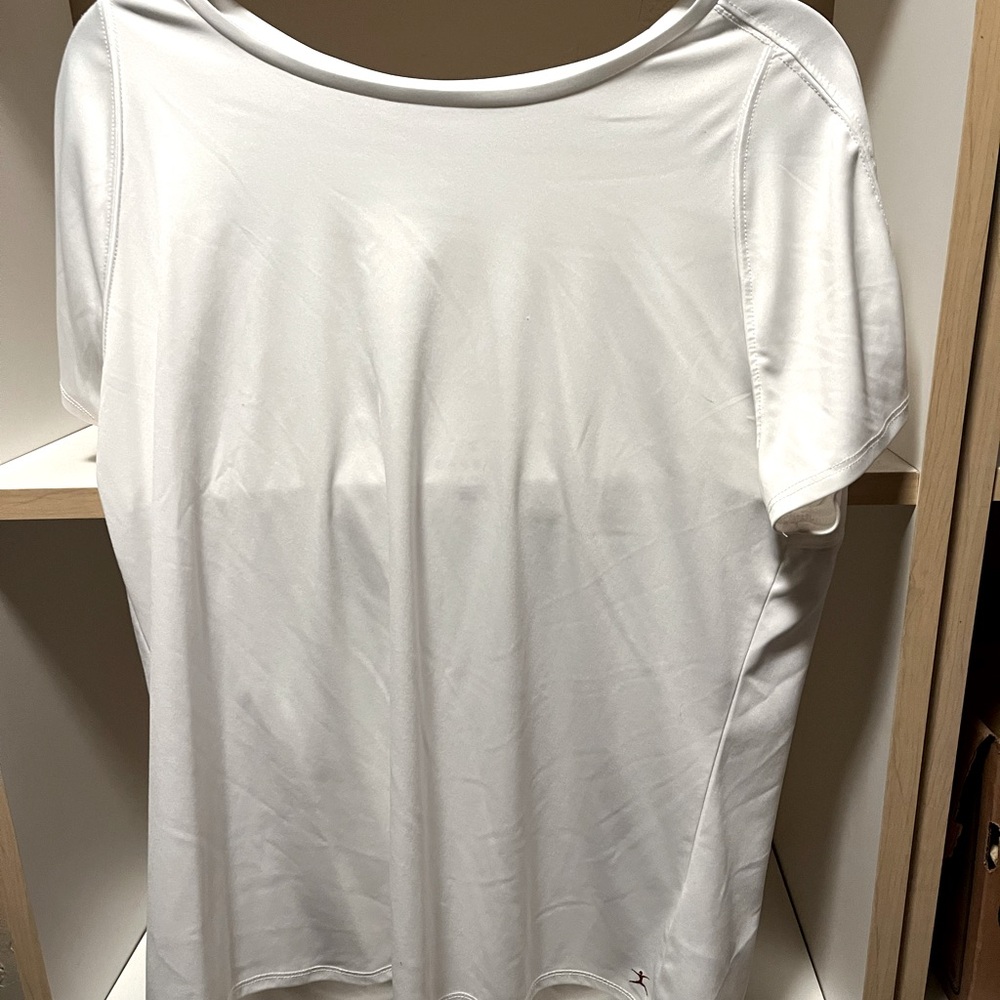 White workout top. Sheer panel on 1/4 of the back side.
